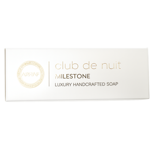 A white rectangular box labeled "Club de Nuit Milestone Luxury Handcrafted Soap" with gold and black text and a circular logo on the left.