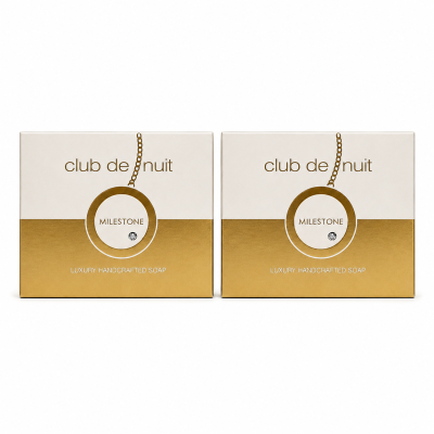 Two bars of Armaf Club De Nuit Milestone unisex soap (130g each), featuring a white and gold design with a chain motif on the front.