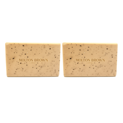 Two Molton Brown Black Pepper Bodyscrub Soap Bars (250g each) with small dark specks are placed side by side on a plain white background.