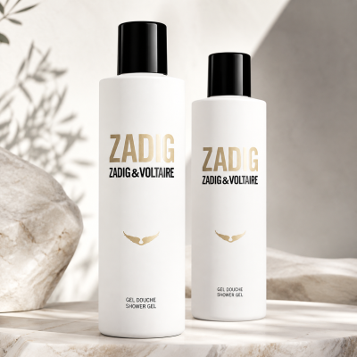 Two bottles of Zadig & Voltaire Zadig Shower Gel for Her (200ml each) with black caps are shown on a marble surface, sunlight casting shadows in the background.