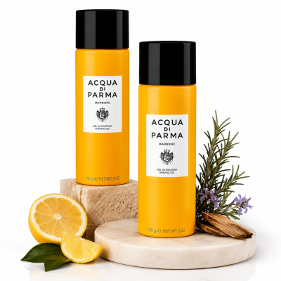 Two 145g bottles of Acqua di Parma Barbiere Shaving Gel for Men rest on marble slabs, accompanied by lemon, rosemary, and lavender sprigs.