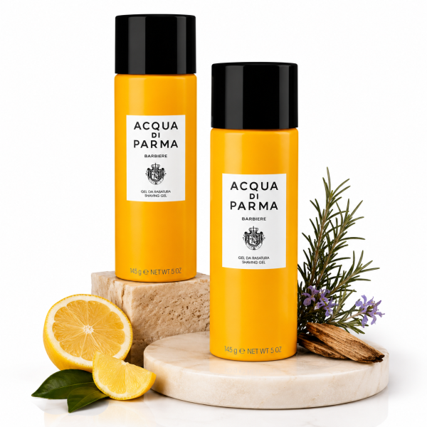 Two 145g bottles of Acqua di Parma Barbiere Shaving Gel for Men rest on marble slabs, accompanied by lemon, rosemary, and lavender sprigs.