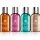 The Molton Brown Woody & Floral Body Care Shower Gel Collection (4x 100ml) features four bottles in a row, each with a unique color and label: black pepper, pink pepper, cypress & sea fennel, and rhubarb & rose.