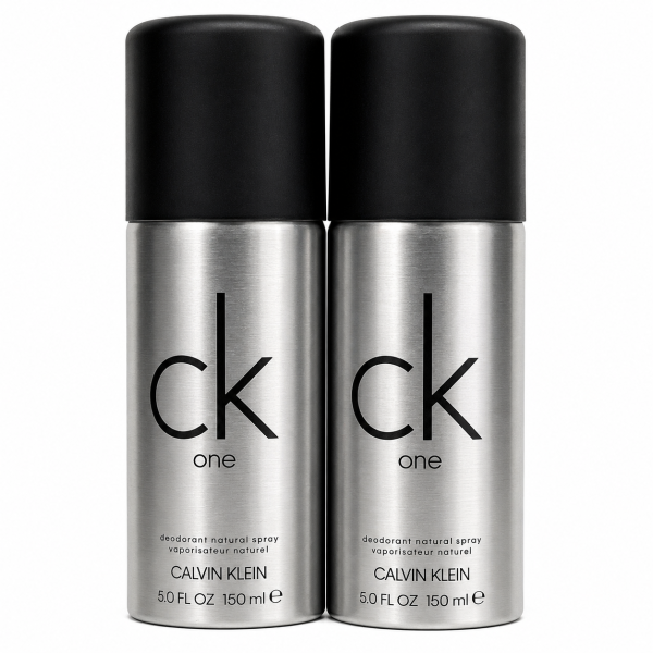 Two silver 150 ml cans of Calvin Klein CK One deodorant natural spray with black caps are placed side by side against a white background. Two silver 150 ml cans of Calvin Klein CK One deodorant natural spray with black caps are placed side by side against a white background.