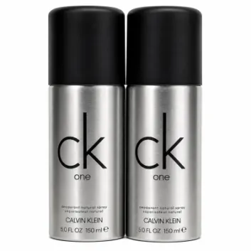Two silver 150 ml cans of Calvin Klein CK One deodorant natural spray with black caps are placed side by side against a white background.