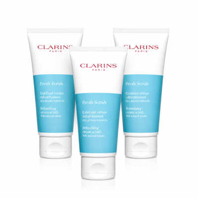 Three tubes of Clarins Paris Fresh Scrub refreshing cream scrub with natural beads, displayed upright against a white background.