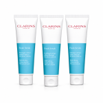 Three tubes of Clarins Paris Fresh Scrub exfoliating cream with blue and white packaging are standing side by side on a white background.