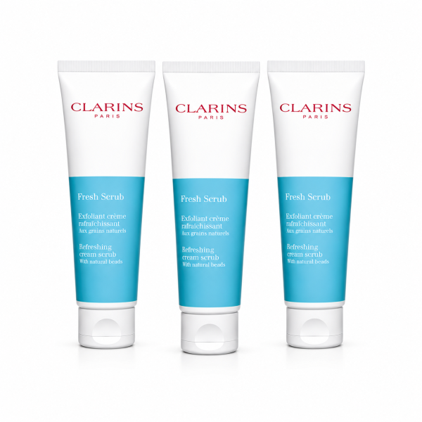 Three tubes of Clarins Paris Fresh Scrub exfoliating cream with blue and white packaging are standing side by side on a white background.