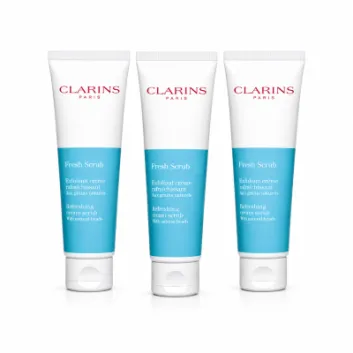 Three tubes of Clarins Paris Fresh Scrub exfoliating cream with blue and white packaging are standing side by side on a white background.