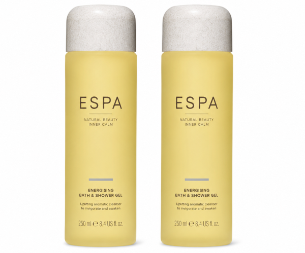 Two yellow bottles of ESPA Energising Bath & Shower Gel, each 250ml, stand side by side against a white background. Two yellow bottles of ESPA Energising Bath & Shower Gel, each 250ml, stand side by side against a white background.
