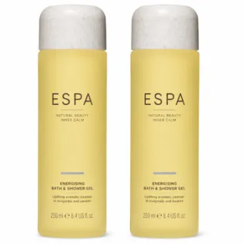 Two yellow bottles of ESPA Energising Bath & Shower Gel, each 250ml, stand side by side against a white background.