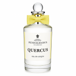 A clear glass bottle of Penhaligon's Quercus eau de cologne with a round stopper and a yellow bow tie, photographed against a white background.