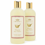 Two bottles of Tocca Cleopatra body wash, each with gold caps, cream-colored liquid, and a label featuring a gold motif and product details.