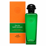 A green bottle of Hermès Eau de Basilic Pourpre EDC Spray, Unisex, 100ml is displayed beside its coordinating orange and green box, both featuring embossed logos and product information.