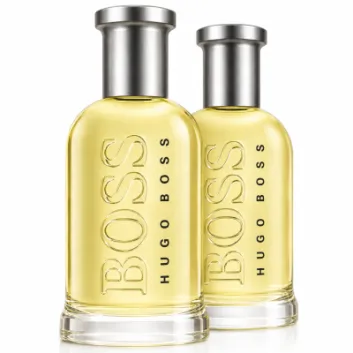 Two bottles of Hugo Boss Bottled Eau de Toilette for Men (100ml each) with silver caps and clear glass filled with light yellow liquid are placed side by side on a white background.