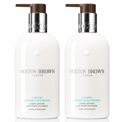 Two white bottles of Molton Brown Coastal Cypress & Sea Fennel Bath and Shower Gel, each 300ml and designed for unisex use, are placed side by side against a white background.