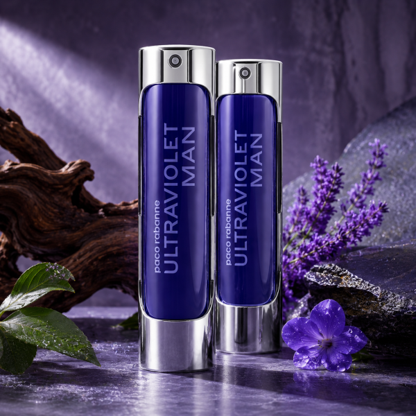 Two bottles of 2x Paco Rabanne Ultraviolet Man EDT 100ml Spray are displayed on a stone surface, surrounded by purple flowers, green leaves, and a piece of wood.