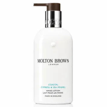 A pair of white bottles of Molton Brown Coastal Cypress & Sea Fennel Bath and Shower Gel (300ml, unisex) with black and silver accents, photographed on a white background.