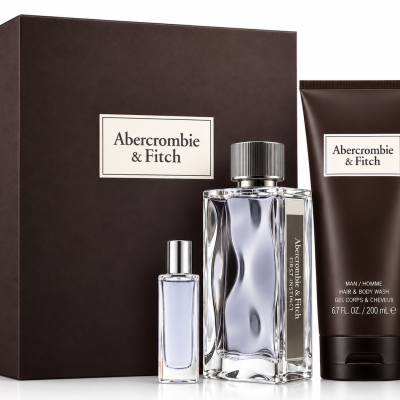 Abercrombie & Fitch First Instinct Gift Set for Men, featuring two EDT spray bottles (one large and one small), a tube of shower gel, and a dark rectangular box in the background.