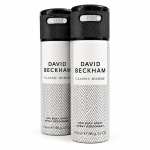Two cans of David Beckham Classic Homme body spray and deodorant, each 150ml, with a white and gray chevron pattern and black caps, standing side by side.