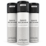 Three cans of David Beckham Classic Homme deodorant body spray, each 150ml, are arranged side by side. The cans feature a black cap and a white herringbone pattern on the body.
