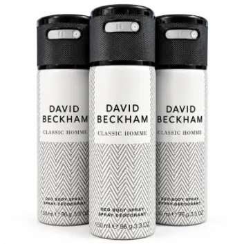 Three cans of David Beckham Classic Homme deodorant body spray, each 150ml, are arranged side by side. The cans feature a black cap and a white herringbone pattern on the body.