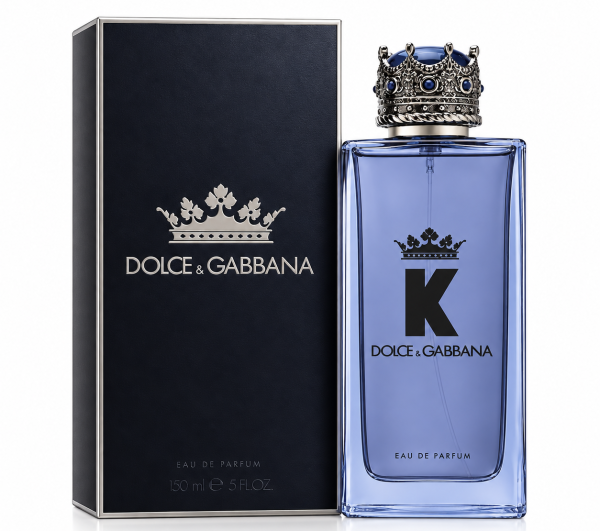 A 150ml spray bottle of Dolce & Gabbana K Eau de Parfum, topped with a distinctive crown-shaped cap, is displayed beside its black box adorned with the brand’s logo and crown motif.