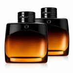 Two 100ml bottles of Mont Blanc Legend Night Eau de Parfum for Men are placed side by side on a white background, featuring sleek, curved amber and black designs with reflective surfaces.