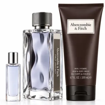The Abercrombie & Fitch First Instinct Gift Set for Men—featuring two eau de toilette bottles in different sizes and a brown tube of shower gel—is displayed upright on a white background.
