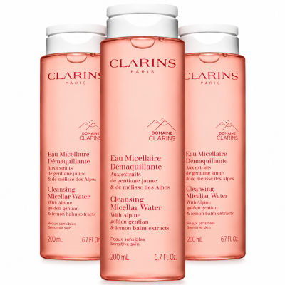 Three 200ml bottles of Clarins Cleansing Micellar Water with pink liquid and white screw caps.
