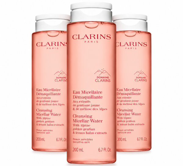 Three 200ml bottles of Clarins Cleansing Micellar Water with pink liquid and white screw caps.