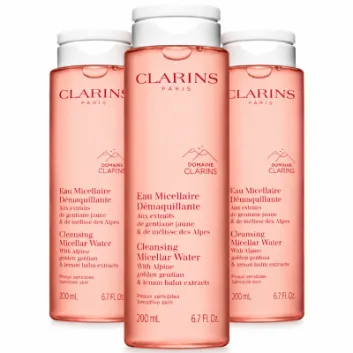 Three 200ml bottles of Clarins Cleansing Micellar Water with pink liquid and white screw caps.