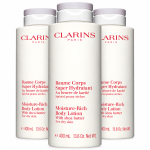 Three 400ml bottles of Clarins Moisture-Rich Shea Butter Body Lotion with red text and grey caps.