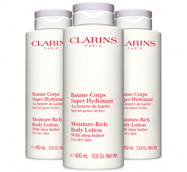 Three 400ml bottles of Clarins Moisture-Rich Shea Butter Body Lotion with red text and grey caps.